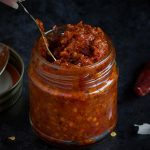 Homemade Red Chilli Paste in lass jar, dark photo