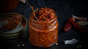 Homemade Red Chilli Paste in lass jar, dark photo