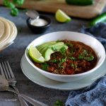 chilli con carne with avocados slices and lime