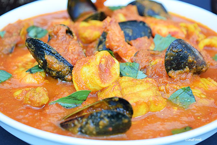Close up picture of Burmese Seafood Curry with mussels, squid and fish