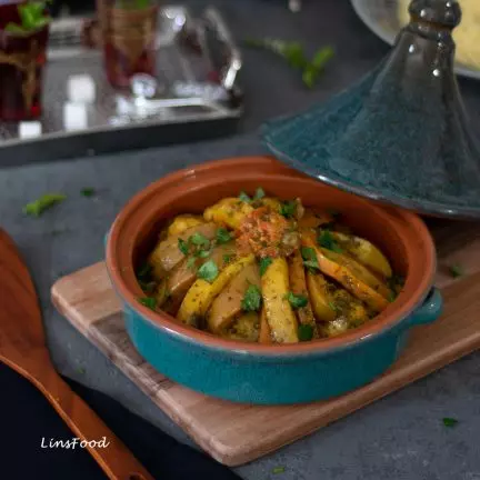Chicken tagine in a tagine with lid half off