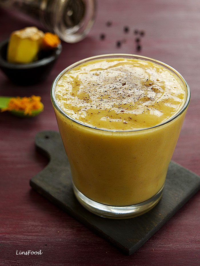 yellow smoothie in a glass