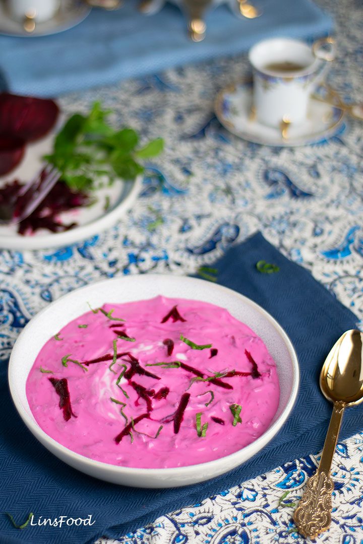 pink yoghurt with beetroot in white bowl with blue paisley tablecloth