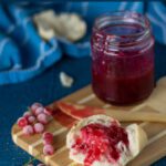 Homemade Redcurrant Jam (aka Redcurrant Jelly) with scones on a small wooden board