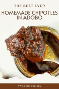 homemade chipotles in adobo on a fork resting on glass jar