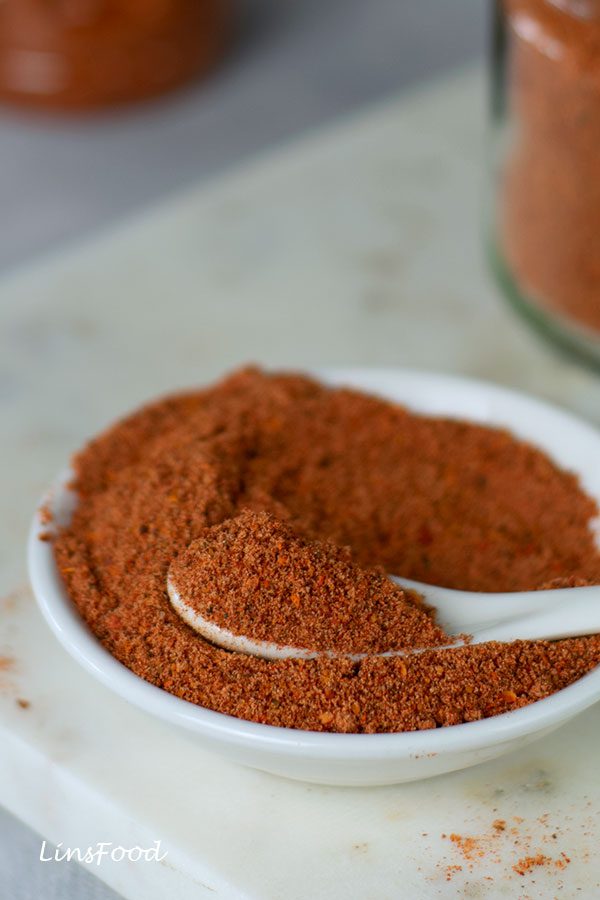 homemade Tajín in a small white bowl with white spoon