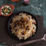 reshteh polo, persian rice with noodles topped with raisins and onions