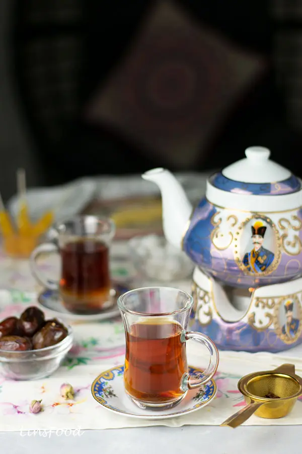 persian tea (black tea) in glasses with Persian teapot and dates