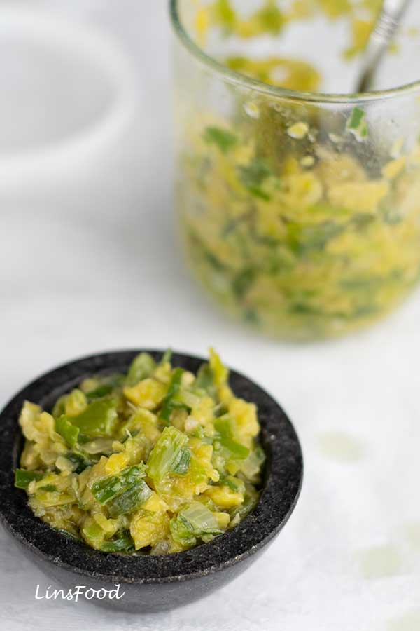 ginger and scallion sambal in a tiny black bowl and glass jar