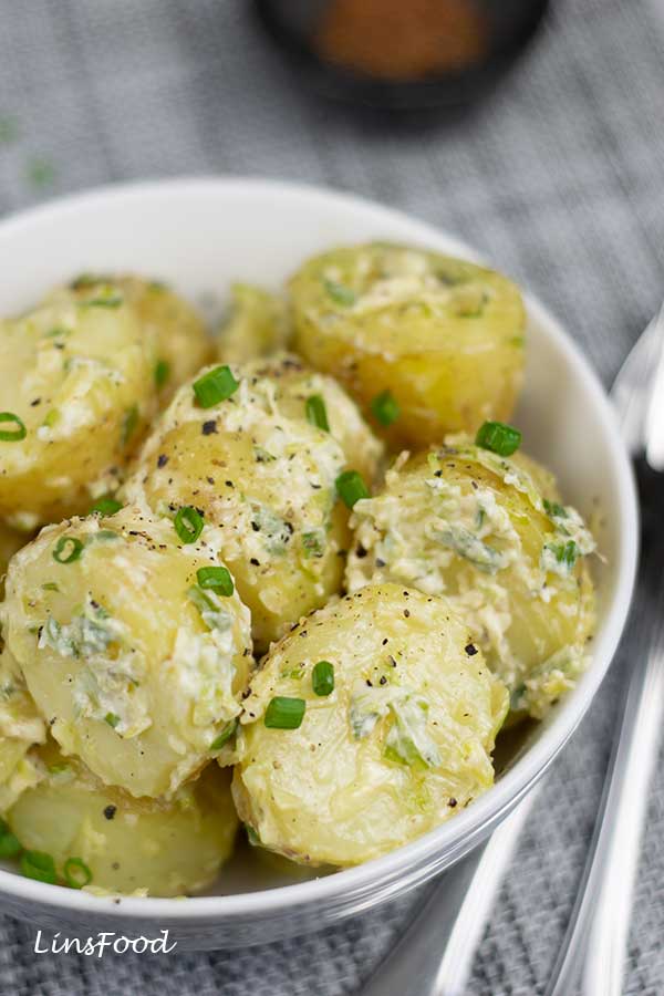 spiced potato salad in a white bowl