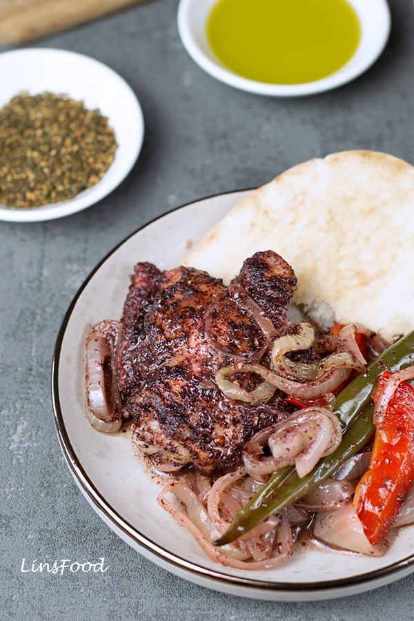 Sumac Chicken on a plate with pita bread
