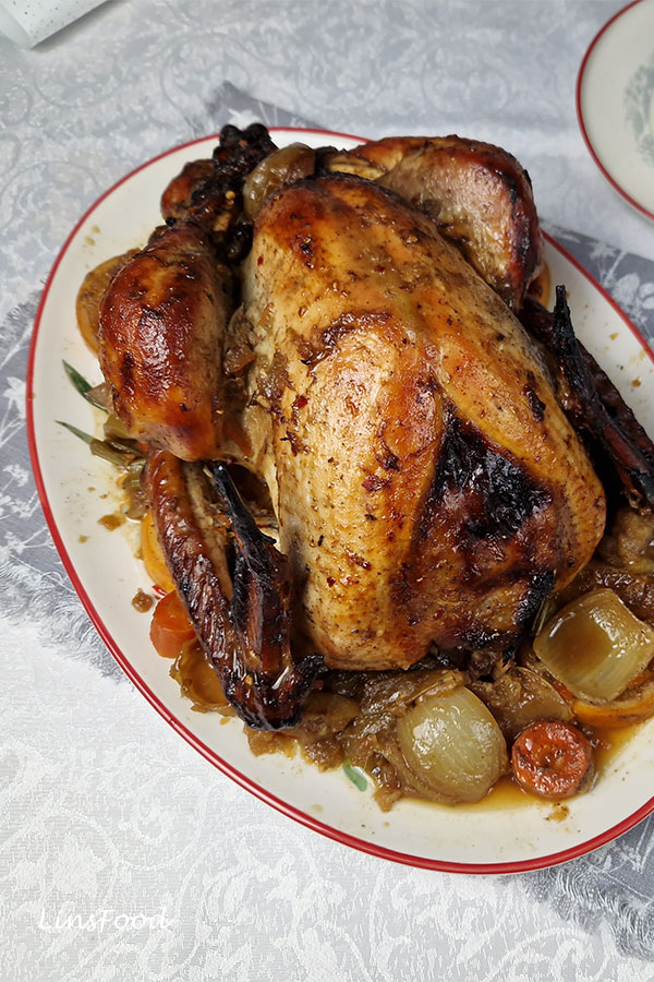 Holiday marmalade roast turkey on oval platter with vegetables and oranges
