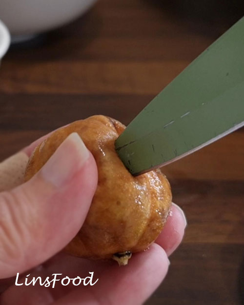 Piercing a soaked brown limoo before adding it to Omani paplou